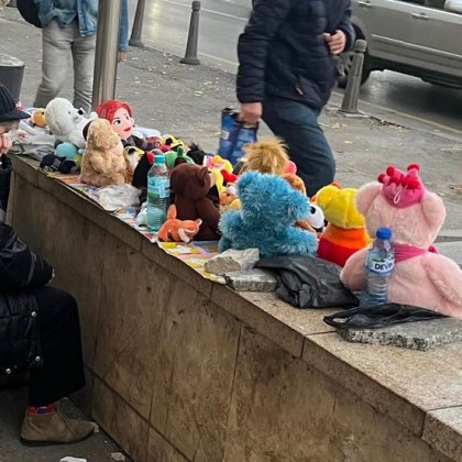  На улица Опълченска в София възрастна дама продава играчки Столичани