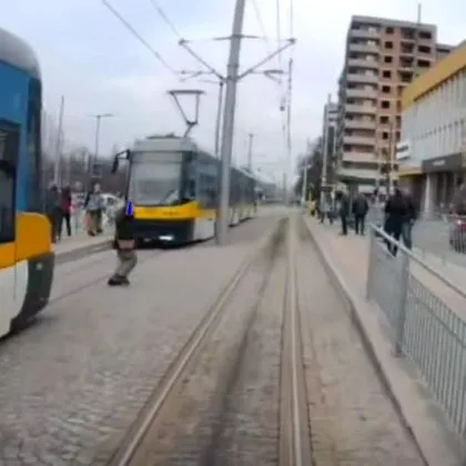 Опасно! Момиче профуча между три трамвая ВИДЕО