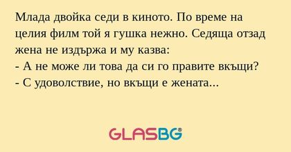 Млада двойка седи в киното. По...